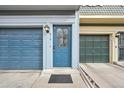 Close-up of a front door and garage with address number, stylish glass, and adjacent parking at 912 S Paris Ct, Aurora, CO 80012