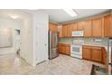 Well-lit kitchen featuring stainless steel refrigerator, modern appliances, and ample counter space at 7371 S Mobile St, Aurora, CO 80016