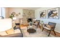 Inviting living room featuring a stone fireplace, stylish seating, and modern decor at 2744 S Newton Way, Denver, CO 80236