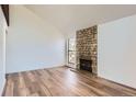 Spacious living room with a cozy stone fireplace and large window providing ample natural light at 6470 S Dayton St # K12, Englewood, CO 80111