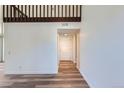 Bright and airy living room boasts hardwood floors and fresh paint leading to the front door at 6470 S Dayton St # K12, Englewood, CO 80111
