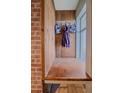 Mudroom entry area with wooden wall and hooks by a window at 4320 Teller St, Wheat Ridge, CO 80033