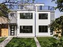 Contemporary two-story house featuring a manicured lawn, modern windows, and sleek design at 1543 Glencoe St, Denver, CO 80220