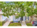 Charming townhouse featuring stone accents, lovely landscaping, and a well-maintained front yard at 8252 S Fillmore Cir, Centennial, CO 80122
