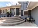 Inviting front porch with seating area and a view of the front yard at 8370 E Princeton Ave, Denver, CO 80237