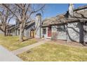 Gray townhome with red front door and walkway at 10731 W 63Rd Ave # A, Arvada, CO 80004