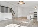 Spacious living room with hardwood floors, lots of natural light, stairs to 2nd floor, and kitchen at 10731 W 63Rd Ave # A, Arvada, CO 80004