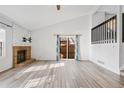 Bright living room with brick fireplace and laminate flooring at 10731 W 63Rd Ave # A, Arvada, CO 80004