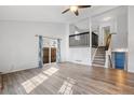 Inviting living room with hardwood floors, stairs to 2nd floor, and access to patio at 10731 W 63Rd Ave # A, Arvada, CO 80004