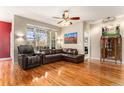 Bright living room with hardwood floors, large windows, and comfortable leather furniture at 11962 W Long Cir # 103, Littleton, CO 80127