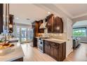 Modern kitchen boasts rich wood cabinetry, stainless steel appliances, quartz countertops, and backyard access at 3530 E 8Th Ave, Denver, CO 80206