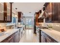 Bright kitchen with modern cabinetry, stainless appliances, quartz countertops and view of the back yard at 3530 E 8Th Ave, Denver, CO 80206