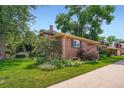 Expansive landscaped yard featuring lush greenery, mature trees, and colorful flower beds, provides a serene outdoor space at 3530 E 8Th Ave, Denver, CO 80206