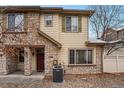 Charming townhome featuring stone accents and neutral siding under a bright sky at 11368 Navajo Cir # B, Denver, CO 80234