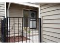 Exterior view of front entrance, enclosed by a black metal fence, and showcasing decorative flowerpots at 7925 W Layton Ave # 605, Littleton, CO 80123