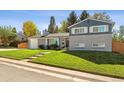 Charming two-story home with a brick exterior, green lawn, and tasteful landscaping enhances curb appeal at 8242 E Briarwood Pl, Centennial, CO 80112
