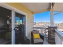 Relaxing balcony featuring a comfortable chair and a view of the surrounding neighborhood at 9471 Ashbury Cir # 202, Parker, CO 80134