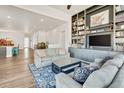 Open-concept living space featuring a fireplace, comfortable seating, and bright natural light at 4863 River Landing Ave, Firestone, CO 80504