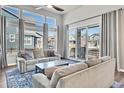 Bright living room featuring large windows, sliding glass door, and comfortable seating at 4863 River Landing Ave, Firestone, CO 80504