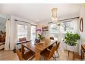 Bright dining room with a wooden table, pendant lighting, and ample natural light at 661 Snowberry St, Longmont, CO 80503