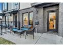 Private patio with seating area, adjacent to townhome entrance at 1403 Yates St, Denver, CO 80204