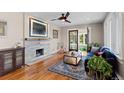 Cozy living room with a stone fireplace, hardwood floors, and natural light at 2601 N Clayton St, Denver, CO 80205