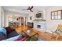 Open-concept living room with hardwood floors, fireplace, and dining area at 2601 N Clayton St, Denver, CO 80205