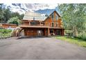 The home features a large deck for entertaining, metal roof, garage, and ample parking space at 10381 Hondah Dr, Littleton, CO 80127