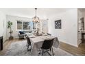 Bright dining room with modern light fixture, wood floors, and stylish decor at 9561 W Wesley Dr, Lakewood, CO 80227