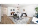 Bright dining room with modern light fixture, wood floors, and stylish decor at 9561 W Wesley Dr, Lakewood, CO 80227