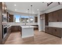 Well-equipped kitchen with stainless appliances, large island, ample countertop space, and stylish pendant lighting at 14283 Currant St, Broomfield, CO 80020