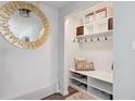 Bright entry with built-in bench, storage shelves, and hooks at 2262 Ammons St, Lakewood, CO 80214