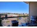 Balcony view showing the grill and fire pit with surrounding buildings in the background at 10111 Inverness Main St # 230, Englewood, CO 80112