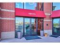 Close up of the entrance to the lofts on a brick building with large glass doors at 10111 Inverness Main St # 230, Englewood, CO 80112