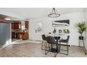 Bright dining room with a view to the kitchen featuring modern lighting and an open floor plan at 201 Greenwood Blvd, Denver, CO 80221