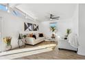 Bright living room featuring a fan, modern decor, and natural light flooding in through large windows at 201 Greenwood Blvd, Denver, CO 80221