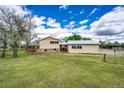 Expansive backyard featuring lush green grass and mature trees at 73 N Dutch Valley Rd, Bennett, CO 80102