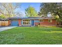 Charming red brick home with a well-manicured lawn and solar panels for energy savings at 2235 Edgewood Dr, Boulder, CO 80304