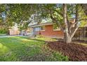Charming red brick home with a well-manicured lawn and mature landscaping at 2235 Edgewood Dr, Boulder, CO 80304