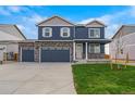 Charming two-story home boasts a three-car garage and manicured lawn at 13466 Valentia St, Thornton, CO 80602