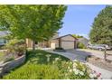 Charming two-story home with a lush front yard, brick accents, and a two-car garage at 3870 S Ouray Way, Aurora, CO 80013