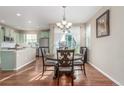 Dining area featuring stylish chandelier and table with backyard views at 129 N Irvington St, Aurora, CO 80018
