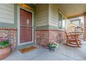 Inviting front porch with brick accents and charming rocking chairs at 129 N Irvington St, Aurora, CO 80018