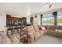 Bright living area with a sectional sofa, seamlessly connecting to the kitchen and breakfast bar seating at 3834 Donnington Cir, Castle Rock, CO 80104