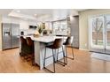 Modern kitchen with an island, stainless steel appliances, and bright white and gray cabinets at 16750 E Prentice Ave, Centennial, CO 80015