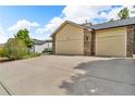 Spacious garage with ample parking on a large driveway and well maintained surrounding landscape at 154 Falcon Cir, Mead, CO 80542