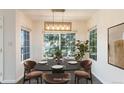 Elegant dining area featuring a modern chandelier and large windows, perfect for entertaining at 3825 Canyon Ranch Rd # 203, Highlands Ranch, CO 80126