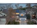Home's exterior with a two car garage and solar panels in a lakeside community at 4814 S Upham Ct, Littleton, CO 80123