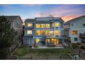 Back of home featuring a spacious backyard with a hot tub, porch, and sunset at 4814 S Upham Ct, Littleton, CO 80123