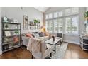 Inviting living room featuring a cozy seating area and abundant natural light from large windows at 19131 E Garden Pl, Centennial, CO 80015